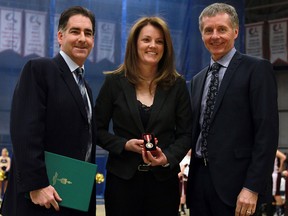 MP Brian Masse, left, is joined by University of Windsor president Alan Wildeman, right, as he presents Chantal Vallee with a Queen's 60th Anniversary Diamond Jubilee medal at the St. Denis Centre. (TYLER BROWNBRIDGE/The Windsor Star)