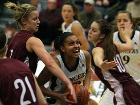 Lancers guard Miah-Marie Langlois, centre, is covered by McMaster's Liz Burns, left, and Rachael Holmes at the St. Denis Centre Wednesday.        (TYLER BROWNBRIDGE/The Windsor Star)