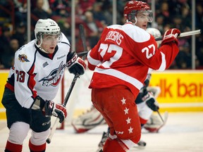 Windsor's Remy Giftopoulos, left, is checked by the Soo's Nick Cousins in the Soo Friday. (Rachele Labrecque/Soo Star)