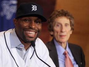 Tigers outfielder Torii Hunter, left, talks to the media with owner Mike Ilitch in the background.  (AP Photo/Carlos Osorio)