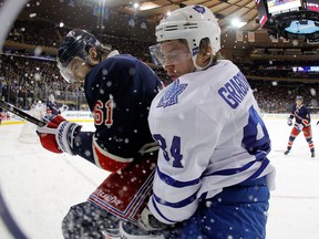 Toronto's Mikhail Grabovski, right, is checked by New York's Rick Nash at Madison Square Garden. (Photo by Jim McIsaac/Getty Images)