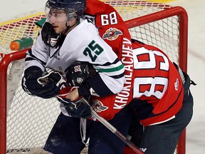 Windsor's Alex Khokhlachev, right, is in a headlock at the hands of Plymouth's Vincent Trocheck at the WFCU Centre. (TYLER BROWNBRIDGE/The Windsor Star)