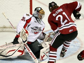 Windsor goalie Jaroslav Pavelka, left, makes a save on Guelph's Brock McGinn at the WFCU Centre. (TYLER BROWNBRIDGE/The Windsor Star)