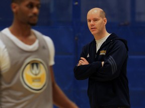 University of Windsor men's basketball coach Chris Oliver, right, is taking a year's sabbatical from his job to study basketball around the world.