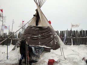(FILES) A lone teepee shelters Attawapiskat Chief Theresa Spence in this January 4, 2012 photo in Ottawa. Spence  been on a hunger strike since Dec.11 on Victoria Island on the Ottawa River in view of Canada's parliament, as part of efforts to press for a meeting with Prime Minister Stephen Harper, to discuss aboriginal living in squalid conditions on reserves. (Getty Images files)