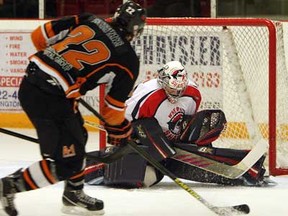 Essex's Dylan Solicki, left, takes a shot against Wheatley's Marc Tremblay during junior C hockey at Essex Arena on Tuesday, January 22, 2013.              (TYLER BROWNBRIDGE / The Windsor Star)