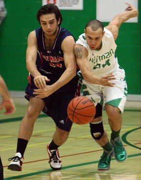 Herman's Tyler Storie, right, battles Holy Names' Jonathan Younan during high school basketball action at Herman Tuesday, (TYLER BROWNBRIDGE/The Windsor Star)