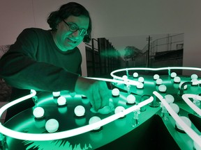 Artist Iftikhar Dadi cleans his efflorescense art pieces before installing them at the Art Gallery of Windsor. The work is part of the Border Cultures exhibit at the gallery. (DAN JANISSE / The Windsor Star)