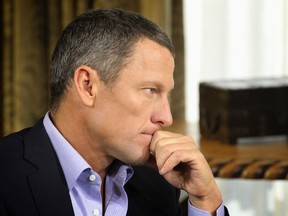 Lance Armstrong listens as he is interviewed by talk show host Oprah Winfrey during taping for the show Jan. 14, 2013. (Courtesy of Harpo Studios Inc.)
