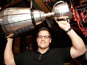 St. Anne grad  J.P. Bekasiak of the Montreal Alouettes celebrates with the Grey Cup at Johnny Shotz Billiard Bar and Cafe in December of 2009. (Scott Webster/The Windsor Star)