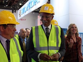 Detroit Mayor Dave Bing, centre, walks past a Honda display during Mayor's walking tour and preview of the Detroit International Auto Show at Cobo Hall Thursday January 10, 2013. (NICK BRANCACCIO/The Windsor Star)
