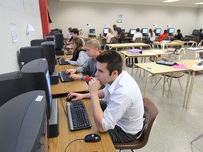 In this file photo, Brennan High School student Brandon Lalonde, right,  Jack Dagnolo, mid,  and Karlee Clarkson, left  work on computers during class on January 13, 2013. (JASON KRYK/The Windsor Star)