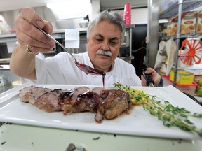 Chef Glenn van Blommestein adds the red wing jelly to the pork tenderloin. (JASON KRYK / The Windsor Star)