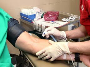 A phlebotomist at the Canadian Blood Services in Windsor prepares a donor for taking blood. (Windsor Star files)