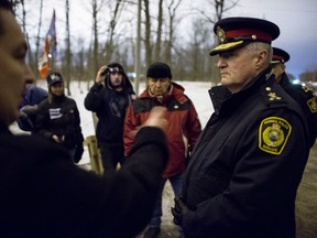 Sarnia Police Chief Phil Nelson, right, meets with Chief Chris Plain of the Aamjiwnaang First Nation at the blockade of the CN tracks in Sarnia Ontario, Wednesday, January 2, 2013 by native protesters. The protest, part of the Idle No More movement, has blocked the tracks for 13 days.THE CANADIAN PRESS/Geoff Robins