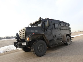 An armoured Ontario Provincial Police vehicle leaves a staging area near Comber Road and Highway 401 following a search for two home invaders.  (JASON KRYK/The Windsor Star)