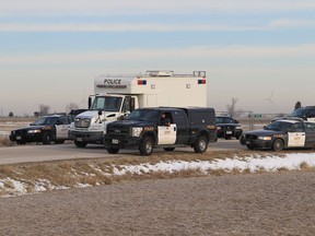 A convoy of Ontario Provincial Police vehicles leave a staging area near Comber Road and Highway 401 following a search for two home invaders.  (JASON KRYK/The Windsor Star)