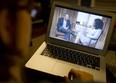 A woman watches on her computer as Oprah Winfrey interviews cyclist Lance Armstrong about doping while competing professionally in the sport. (SAUL LOEB / AFP / Getty Images)
