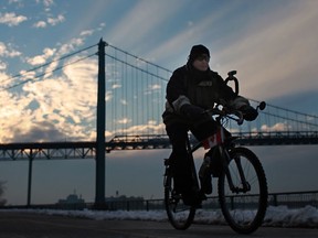 A man rides his bicycle along Windsor's riverfront in frigid temperatures just before sunset, Saturday, January 5, 2012.  (DAX MELMER / The Windsor Star)