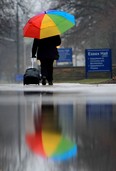 A pedestrian walks with an umbrella at the University of Windsor during a rain shower in this 2013 file photo. (JASON KRYK/The Windsor Star)