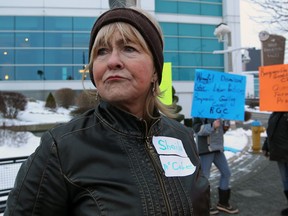 Sheila McCabe walks along Riverside Drive East with friends during a protest to bring awareness to her dismissal, Thursday January 3, 2013. ( NICK BRANCACCIO/The Windsor Star)