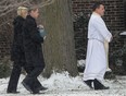 A funeral service was held Monday, Jan. 21, 2013, for Alison Easton, Alex Corchis and Katie Corchis at the All Saints Church in Windsor, Ont. A brief ceremony outside the church followed. Here, Jon Corchis, carries an urn to the ceremony.  (DAN JANISSE/The Windsor Star)