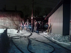 Fire crews extinguish hot spots at a fire at Windsor Body and Fender on Jan. 4, 2013. (CARSON BUCHANAN/Special To The Star)