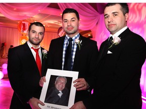 WINDSOR, ONT., Saturday, January 26, 2013 -- Brothers John, Paul and Patrick Germanese attend the 16th annual Transition to Betterness gala held at the Ciociaro Club on Satuday, January 26, 2013. The brothers are holding up a photo of their father, Joe, who died of cancer last year and was honoured at this year's event. (REBECCA WRIGHT/ The Windsor Star)