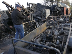 Jim Desjardins surveys the damage to his garage Thursday, Jan. 17, 2013, at his home in the 1700 block of Lesperance Rd. in Tecumseh, Ont. An early morning fire destroyed the structure as well as several vintage motorcycles and antique collectibles.  (DAN JANISSE/The Windsor Star)