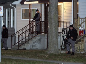 Windsor police work outside a home on Bridge Avenue in Windsor on Tuesday, January 15, 2013. Windsor police responded to a report of a gun in the house. Two suspects were taken into custody. (TYLER BROWNBRIDGE / The Windsor Star)