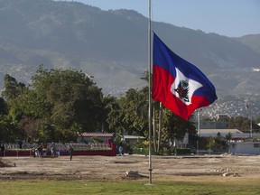 A Haitian national flag flies at half-mast on the front lawn of the former National Palace, marking the 3rd anniversary of the devastating 7.0 magnitude earthquake in Port-au-Prince  (AP Photo/Dieu Nalio Chery)
