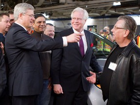 Canadian Prime Minister Stephen Harper (left) is greeted by Ken Lewenza (right) President of the Canadian Auto Workers at Ford Motor plant in Oakville Ont. on Friday January 4, 2013. Harper announced the renewal of the automotive Innovation Fund. THE CANADIAN PRESS/Chris Young