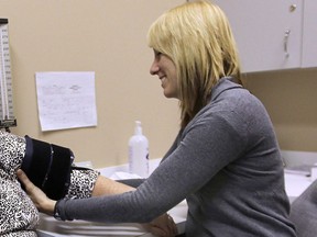 Nurse practitioner Kelly Humphrey from the Windsor Essex Community Health Centre takes blood pressure reading from a patient in March, 2012. (Windsor Star filess)
