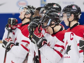 Canada captain Ryan Nugent-Hopkins, right, and Jonathan Drouin, centre, hangs their heads with teammates after being defeated by Team USA during third period semi-final IIHF World Junior Championships hockey action in Ufa, Russia on Thursday, Jan. 3, 2013. THE CANADIAN PRESS/Nathan Denette