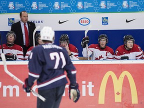 Canada Team looks on as Team USA forward Ryan Hartman (21) looks at Canada's bench in the the final minute during third period semi-final IIHF World Junior Championships hockey action in Ufa, Russia on Thursday, Jan. 3, 2013. THE CANADIAN PRESS/Nathan Denette