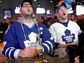 WINDSOR, ONT., Saturday, January 19, 2013 -- Toronto Maple Leafs fans Daryl Berthiaume and Jerome Bracken take in some hockey games on day one of the NHL season after a 113-day lockout at John Max Sports and Wings on Saturday, January 19, 2013. (REBECCA WRIGHT/ The Windsor Star)