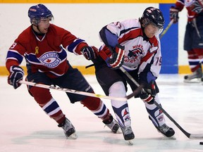 The Wheatley Sharks Brendon Anger shields the puck from the Belle River Canadiens Aidan Wiebenga at Belle River Arena on Friday, January 4, 2013.      (TYLER BROWNBRIDGE / The Windsor Star)