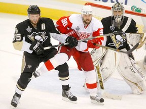 Detroit's Tomas Holmstrom, centre, battles Sergei Gonchar, left, and goaltender Marc-Andre Fleury of the Pittsburgh Penguins during Game 3of the 2008 NHL Stanley Cup Finals at Mellon Arena on May 28, 2008 in Pittsburgh. (Dave Sandford/Getty Images)
