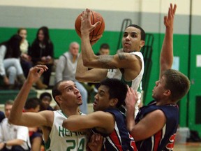 Herman's Demetrias Kah, top, fires a shot over Holy Names players during high school basketball action at Herman Tuesday, January 8, 2013. (TYLER BROWNBRIDGE / The Windsor Star)