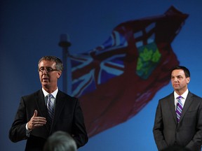 In this file photo, Dave Brister, left,  joins Ontario Progressive Conservative Leader TIm Hudak as he delivers his When The Money Runs Out presentation at the Canadian Transportation Museum in Essex on Thursday, January 17, 2013. (Windsor Star files)