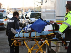 Paramedics transport a man from his home in the 1300 block of Oak Avenue in Windsor on Friday, January 4, 2013. Police were on scene investigating the possible home invasion.          (TYLER BROWNBRIDGE / The Windsor Star)