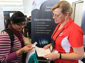 St. Clair College student Neha Chana, left, talks with Autodata Solutions recruiter Monique Bontje during a St. Clair College/University of Windsor job fair on Jan. 22, 2013. (Jason Kryk/The Windsor Star)