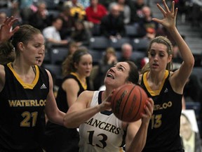 Windsor's Bethanie Wachna, centre, is defended by Waterloo's Kate Kuntze, left, and Kayla Karl during OUA women's basketball action at the St. Denis Centre, Sunday, January 13, 2013. (DAX MELMER/The Windsor Star)