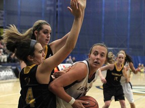 Windsor's Jessica Clememcon, right, battles against the Waterloo Warriors at the St. Denis Centre, Sunday, January 13, 2013.  (DAX MELMER / The Windsor Star)