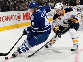 Toronto's Nikolai Kulemin, left,  battles Buffalo's Cody Hodgson during NHL action at the Air Canada Centre January 21, 2013 in Toronto, Ontario, Canada.  (Photo by Abelimages/Getty Images)