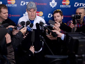 Maple Leafs captain Dion Phaneuf, centre, talks with the media following an informal practice in Toronto Thursday January 10 , 2013. (Chris Young/The Canadian Press).