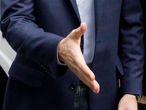 Former Ontario Liberal leader Dalton McGuinty offers a handshake in this September 2011 file photo. (Tyler Anderson / The National Post)