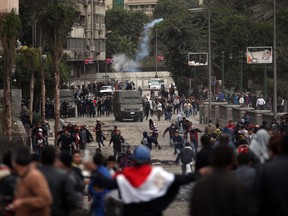 Egyptian protesters clash with riot police near Tahrir Square, Cairo, Egypt, Monday, Jan. 28, 2013. (AP Photo/Khalil Hamra)