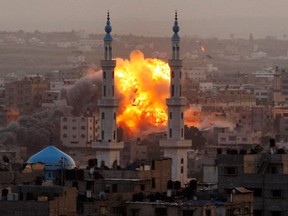 In this Nov. 17, 2012 file photo, smoke rises during an explosion from an Israeli forces strike in Gaza City. Peacemaking with the Palestinians, once the main issue by far in Israeli politics, has been strikingly absent from the campaign for next month's general election. After years of public frustration with failed peace efforts, Prime Minister Benjamin Netanyahu's badly divided challengers are trying instead to tap the economic frustrations of the middle class and a widespread resentment of perks enjoyed by fervently devout Jews.(AP Photo/Hatem Moussa, File)