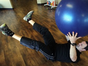 Mike Bates, owner of Refine Fitness, demonstrates core strengthening exercises. (NICK BRANCACCIO / The Windsor Star)